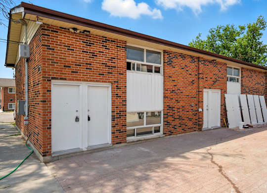 A red brick building with white garage doors.